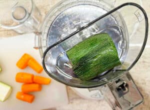 Zucchini in the top of the food processor before shredding