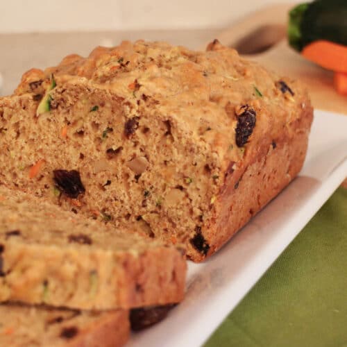 Zucchini Carrot bread sliced on a white serving platter.