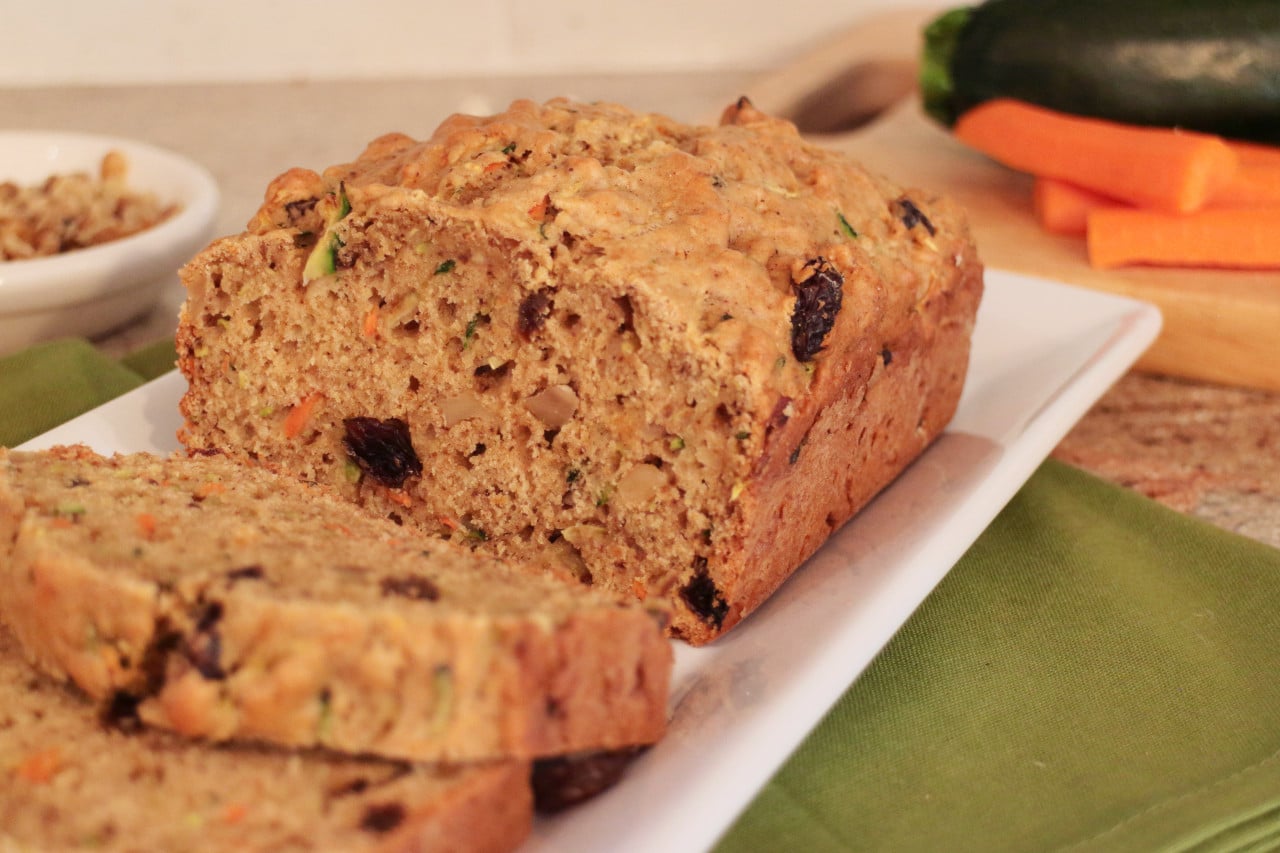 Zucchini Carrot bread sliced on a white serving platter.