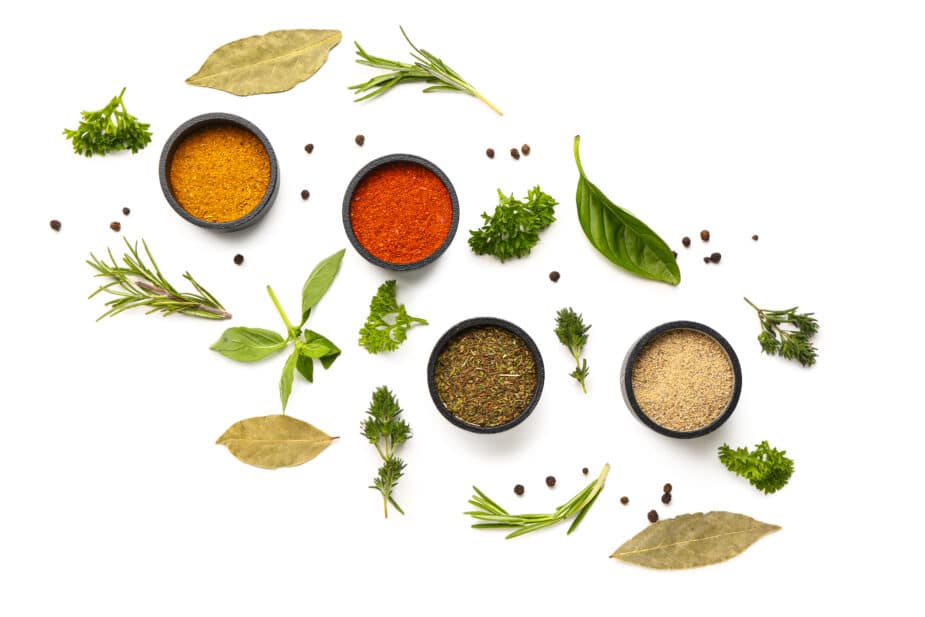 Composition with fresh aromatic spices and herbs on a white background