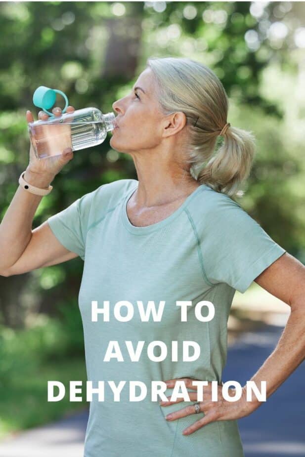 Middle age woman drinking water after a walk outside.