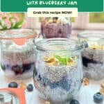 4 jars of lemon blueberry chia pudding on a white table in front of a sunny window.