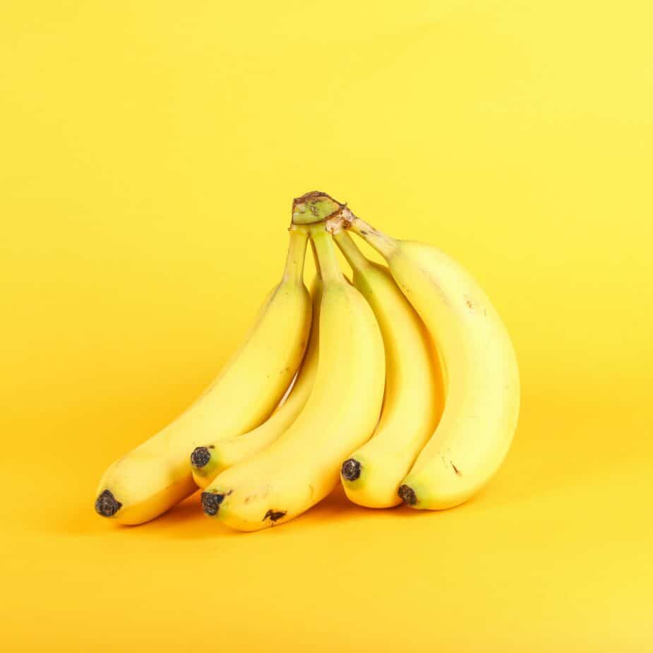 Bananas in front of a yellow background