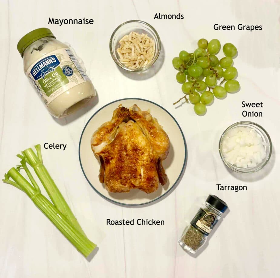 Ingredients used to make Chicken salad with grapes and almonds on a white marble counter