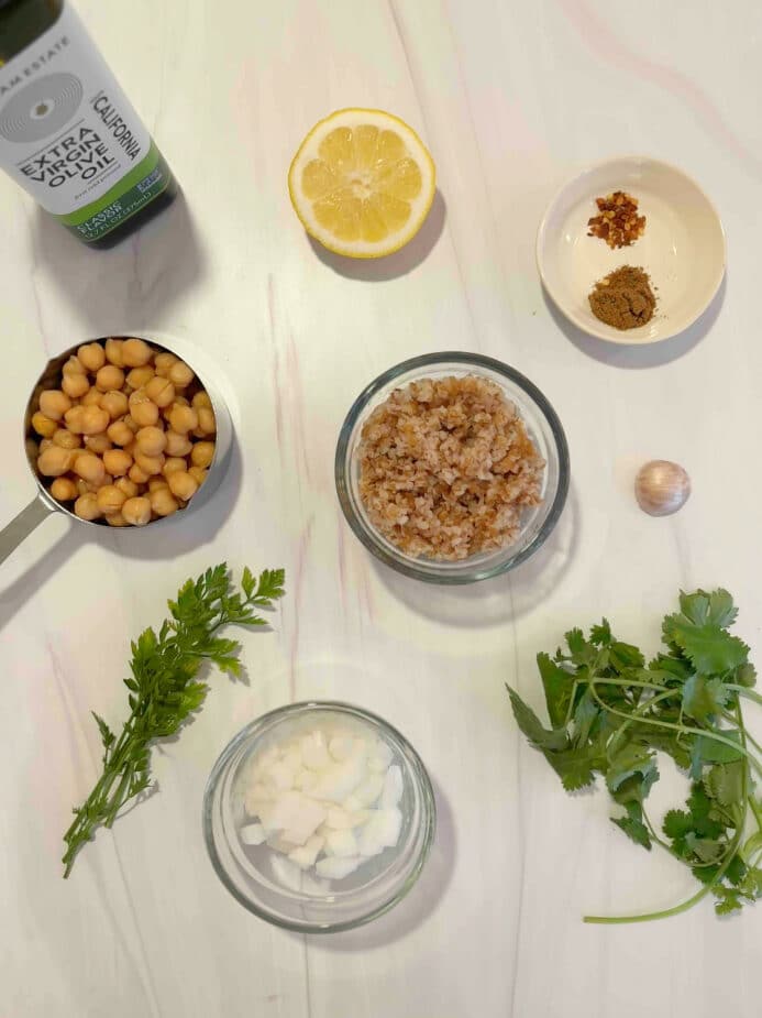 Ingredients used to make falafels on a marble counter