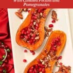 2 Honeynut squash on a white platter topped with candied pecans and pomegranate seeds