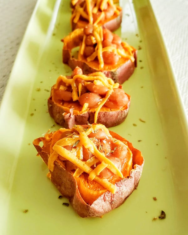 Sweet potato cups filled with baked beans and topped with a little shredded cheese