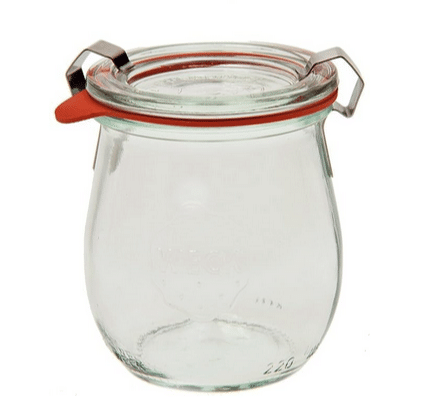 A clear glass jar with a glass top that is held in place by stainless clips and a silicon ring helps seal the jar