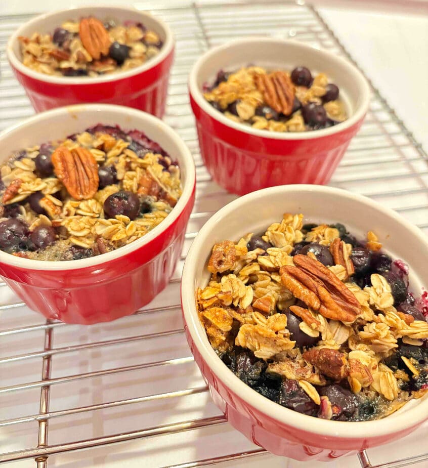 4 blueberry oats cups cooling on a wire rack.