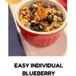 One blueberry oatmeal cup on a white table with a blue napkin on the side